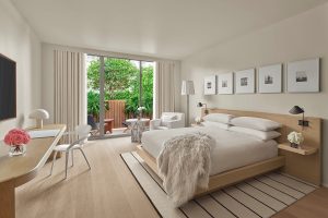 EDITION Tampa guestroom in white with views over Tampa at sunset